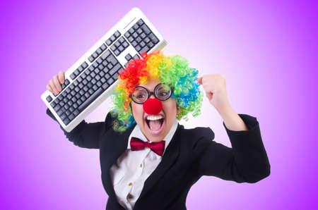 Funny clown with keyboard on whiteの写真素材