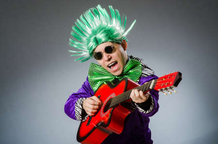 Funny man playing guitar in musical conceptの写真素材