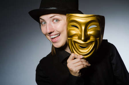 Woman with mask in funny conceptの写真素材
