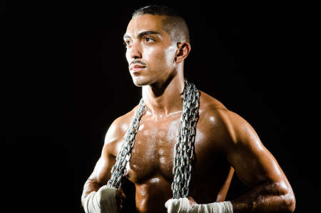 Muscular man with metal chainの写真素材