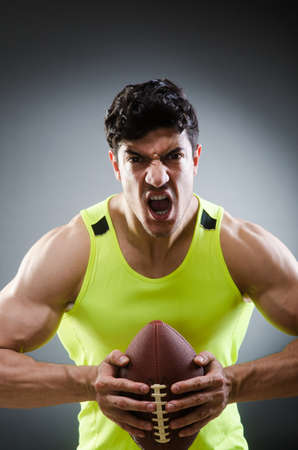 Muscular man with american footballの写真素材