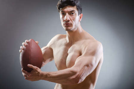 Muscular man with american footballの写真素材