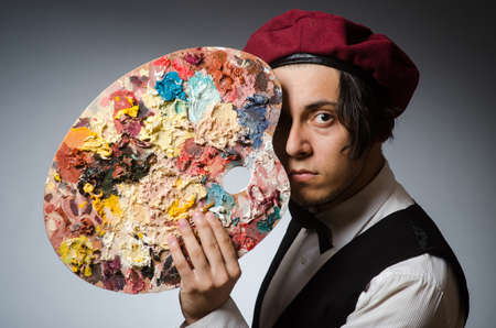 Funny artist in dark studioの写真素材