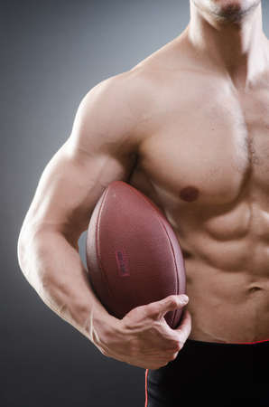Muscular man with american footballの写真素材