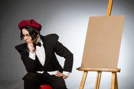 Funny artist in dark studioの写真素材