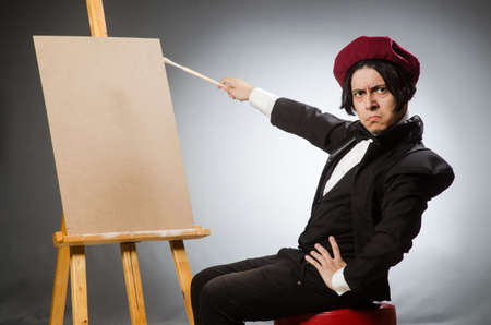 Funny artist in dark studioの写真素材