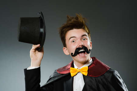 Funny magician man wearing tophat