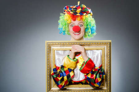 Clown with picture frame in funny conceptの写真素材