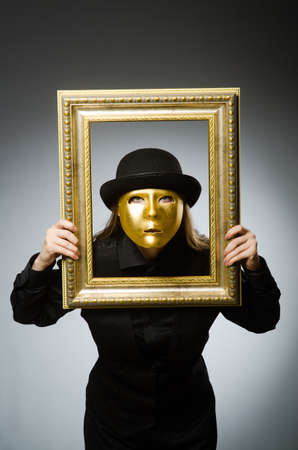 Woman with mask in funny conceptの写真素材