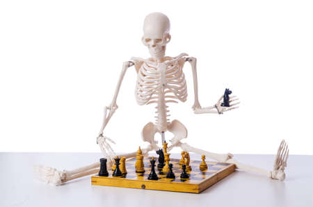 Skeleton playing chess game on whiteの写真素材