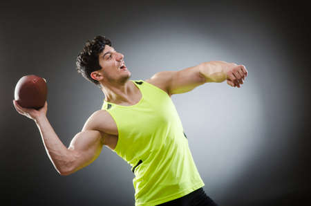 Muscular man with american footballの写真素材