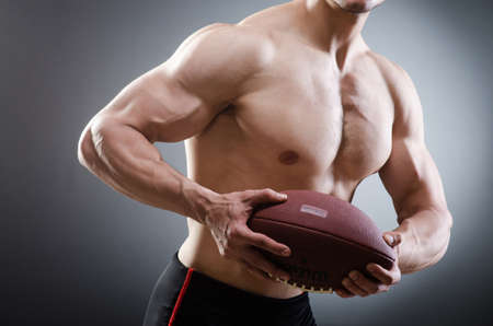 Muscular man with american footballの写真素材