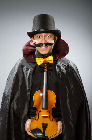 Funny violin player wearing tophatの写真素材