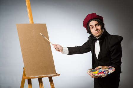 Funny artist in dark studioの写真素材