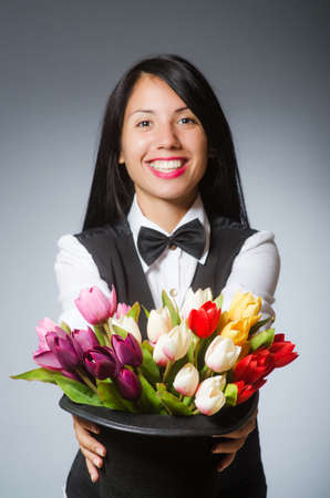 Woman with flowers in hatの写真素材