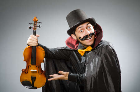 Funny violin player wearing tophatの写真素材