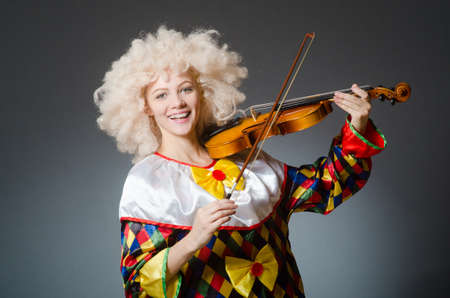 Clown in funny concept on dark backgroundの写真素材