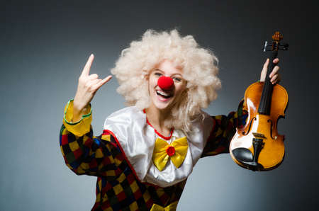 Clown in funny concept on dark backgroundの写真素材