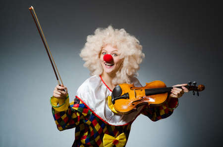 Clown in funny concept on dark backgroundの写真素材