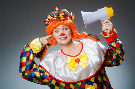 Clown in funny concept on dark backgroundの写真素材