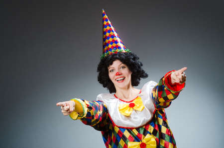 Clown in funny concept on dark backgroundの写真素材