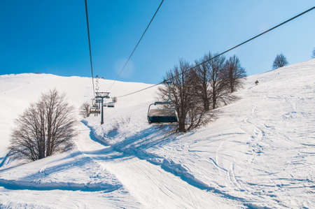 Ski lifts durings bright winter day
