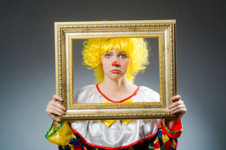 Clown in funny concept on dark background