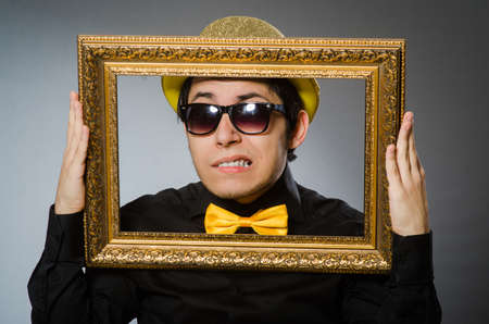 Funny man with picture frameの写真素材