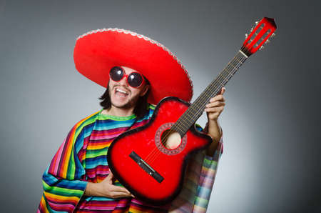 Mexican playing guitar wearing sombreroの写真素材