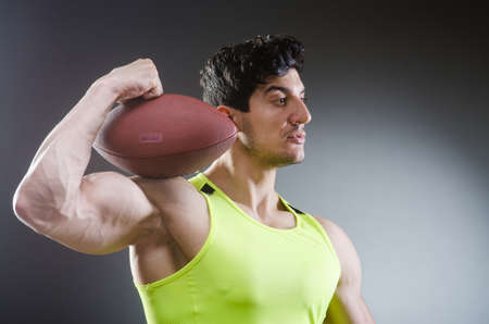 Muscular man with american footballの写真素材