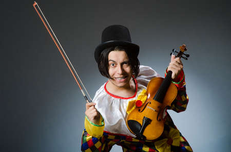 Funny violin clown player in musical conceptの写真素材