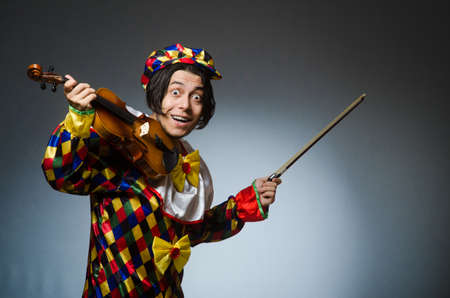 Funny violin clown player in musical conceptの写真素材