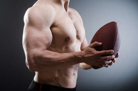 Muscular man with american footballの写真素材