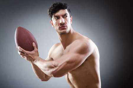 Muscular man with american footballの写真素材