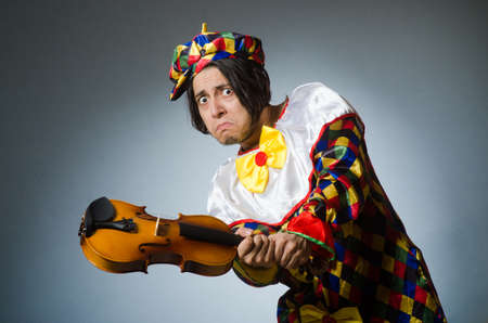 Funny violin clown player in musical conceptの写真素材