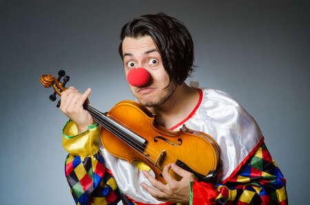 Funny violin clown player in musical conceptの写真素材