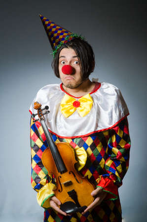 Funny violin clown player in musical conceptの写真素材