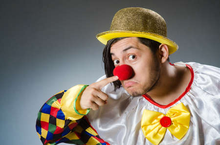 Funny clown against dark backgroundの写真素材