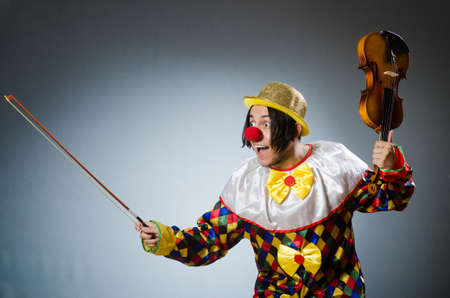 Funny violin clown player in musical conceptの写真素材