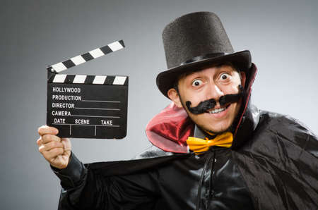 Funny man with movie clapboardの写真素材