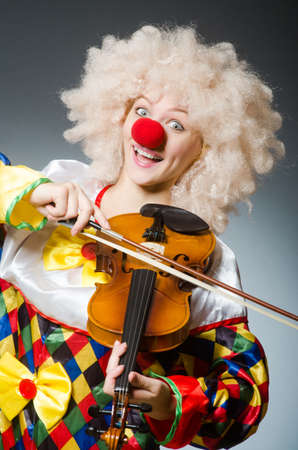 Clown in funny concept on dark backgroundの写真素材