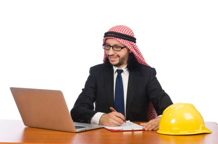 Arab man with computer and hardhatの写真素材