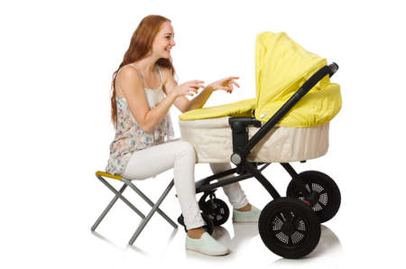 Woman with baby and pram isolated on whiteの写真素材
