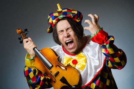 Funny violin clown player in musical concept