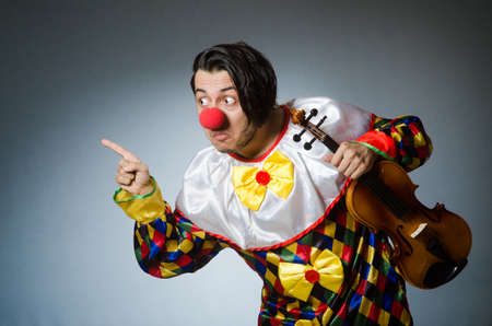 Funny violin clown player in musical conceptの写真素材