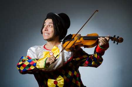 Funny violin clown player in musical conceptの写真素材