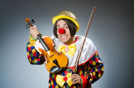Funny violin clown player in musical concept