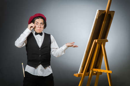 Funny artist in dark studioの写真素材