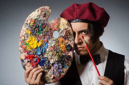 Funny artist in dark studioの写真素材