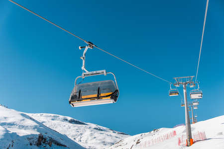 Ski lifts durings bright winter day